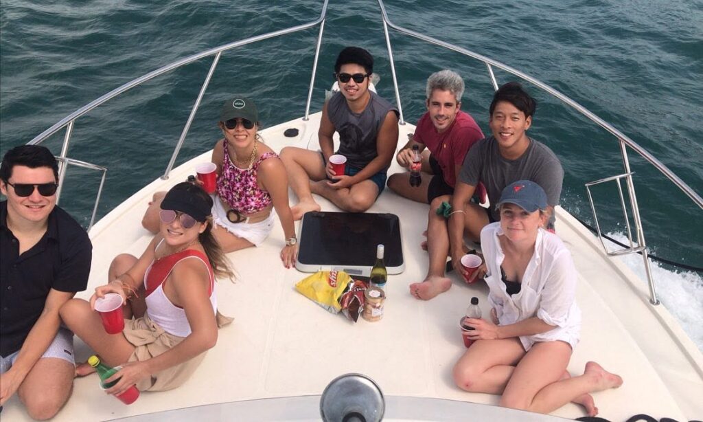 Group of friends relaxing on the bow of a Sea Friends yacht