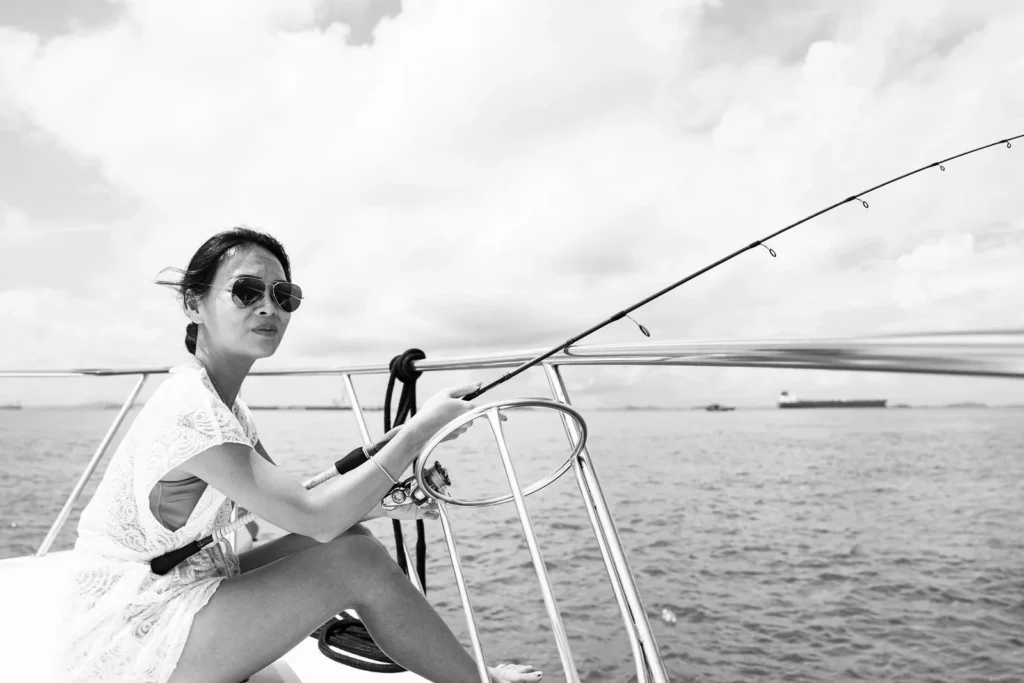 Guest fishing from the bow on a Sea Friends fishing charter in Singapore