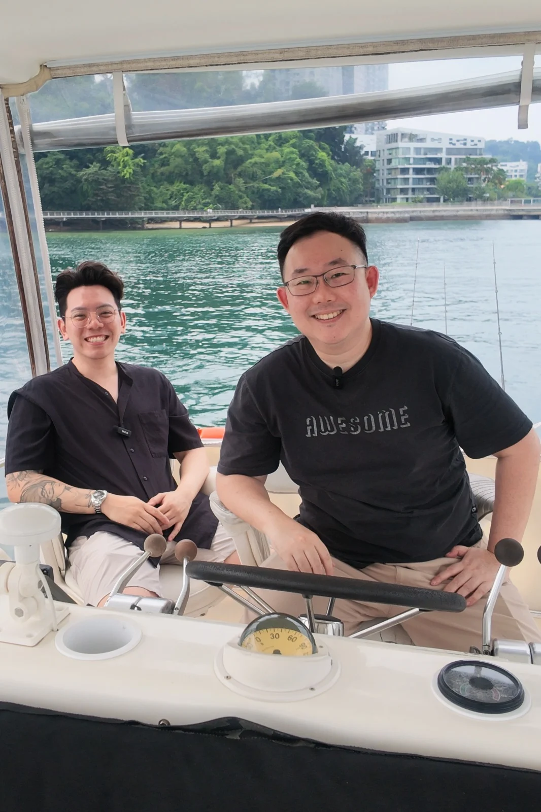 Sea Friends founders on the helm of a charter yacht in Singapore