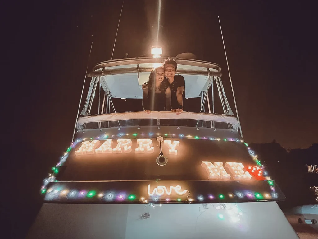 Marry Me light-up sign on a Sea Friends yacht at night