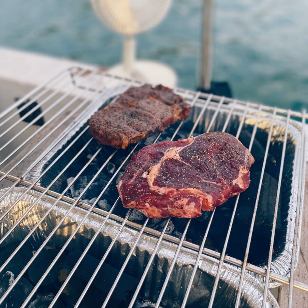 Steaks on the BBQ grill onboard a Sea Friends yacht