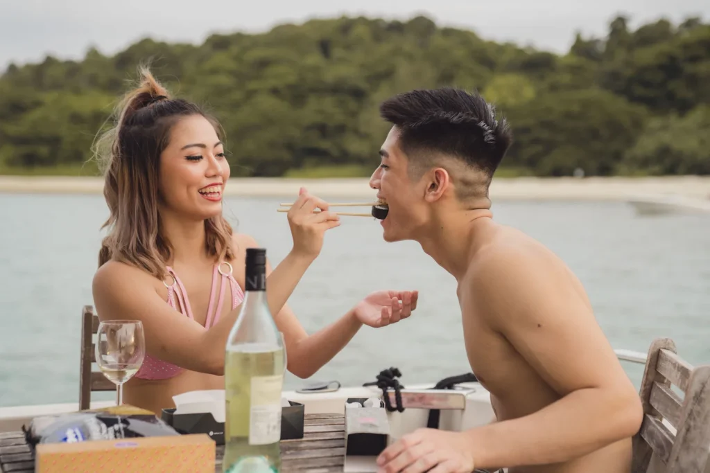 Couple enjoying food and wine on deck